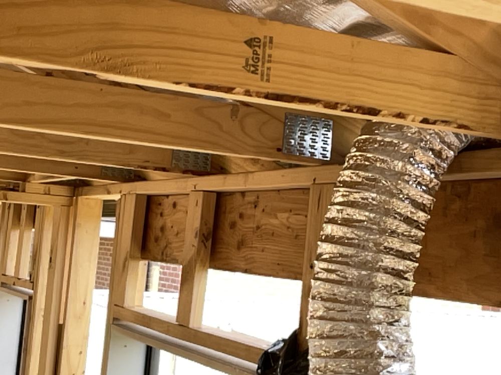 Truss grips not fitted, leaving the trusses without their tie-down hardware, found during a frame inspection in Officer