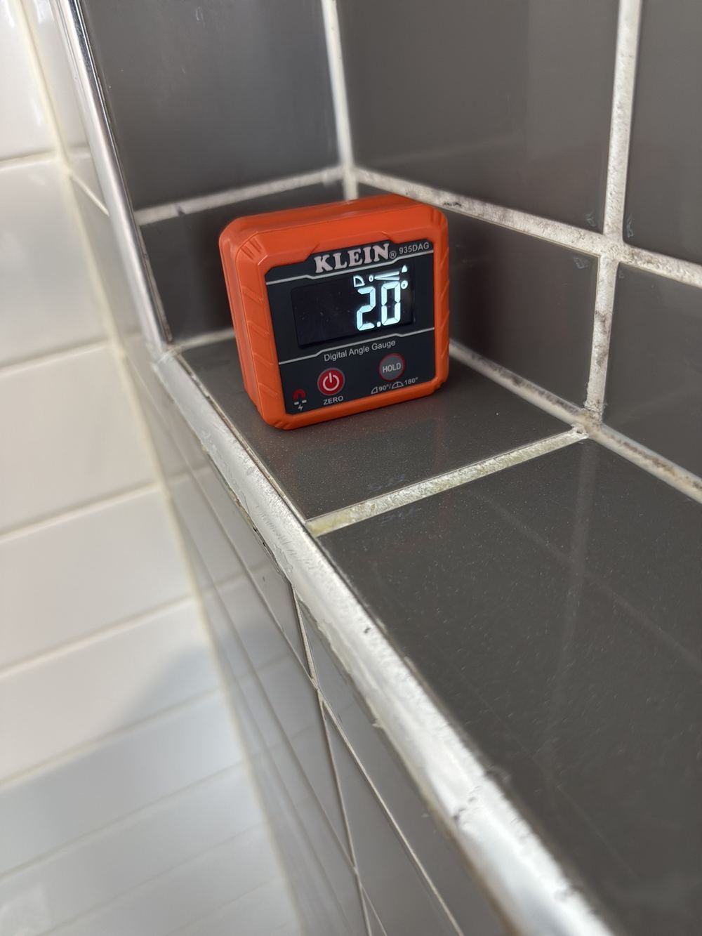 Shower niches sloping back towards the wall, so water pools instead of draining, found during a pre-purchase inspection in Officer
