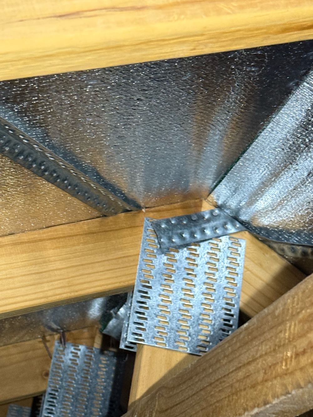 Roof bracing strap slack and not nailed off at each truss, found during a pre-purchase inspection in Officer