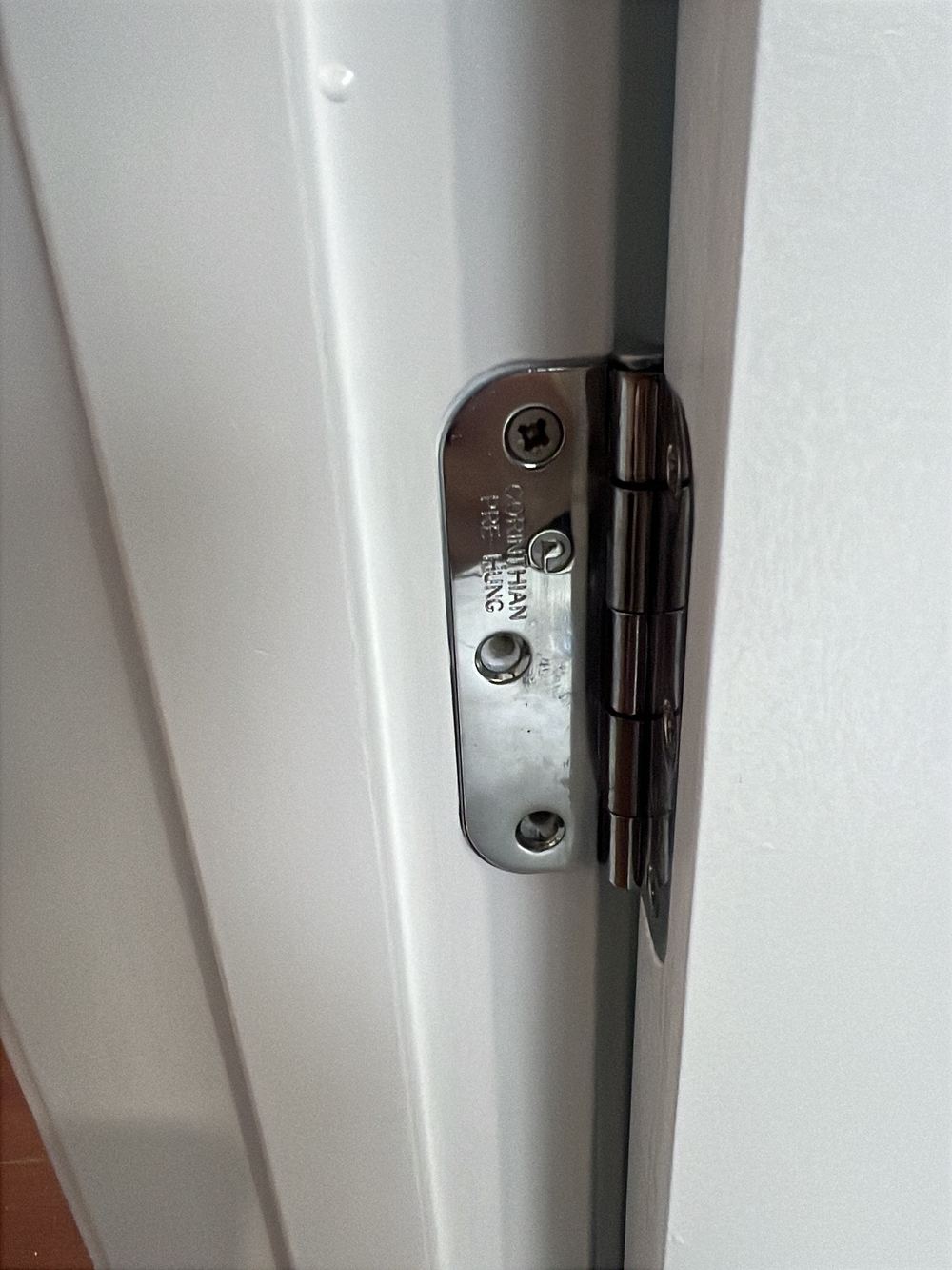 Door hinge with screws missing, loosening how the door hangs, found during a pre-purchase inspection in Officer