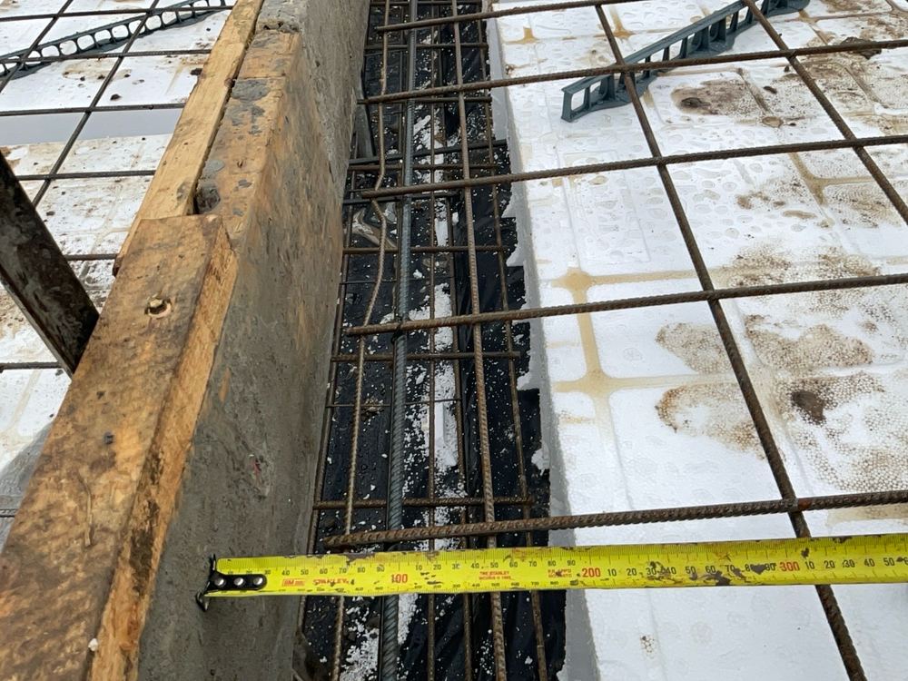 Bars across a footing step extended less than the 300mm the detail needs, found during a slab pre-pour inspection in Officer